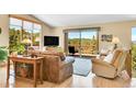 A sun-drenched living room with expansive windows, hardwood floors, and mountain views at 10786 Marclif Rd, Conifer, CO 80433