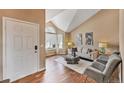 Inviting living room with high vaulted ceilings, hardwood floors, and modern décor at 9443 Palisade Ct, Highlands Ranch, CO 80130