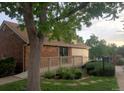 Brick building with well-maintained landscaping and accessible wooden ramp at 14282 E Radcliff Cir, Aurora, CO 80015