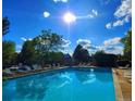 Sparkling pool with lounge chairs, set against a beautiful sky at 14282 E Radcliff Cir, Aurora, CO 80015