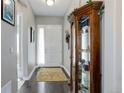 Welcoming entryway with hardwood floors, decorative rug, and glass display case adding a touch of elegance at 4767 S Odessa St, Centennial, CO 80015