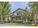 A two-story home with mixed brick and siding, complemented by mature trees and well-kept landscaping at 5892 W 94Th Pl, Westminster, CO 80031
