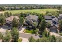 Beautiful two-story home near golf course featuring manicured landscaping, stone accents, and a two car garage at 7120 Forest Ridge Cir, Castle Pines, CO 80108