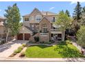 Beautiful two-story home with stone accents, an oversized two car garage, and a well-manicured lawn at 7120 Forest Ridge Cir, Castle Pines, CO 80108