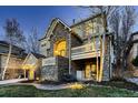 The rear exterior shows stone accents, large windows, and access to the backyard at 7120 Forest Ridge Cir, Castle Pines, CO 80108