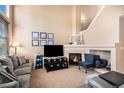 A cozy fireplace adds charm to this spacious living room at 23235 York Ave, Parker, CO 80138