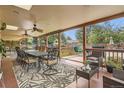 Large covered deck with ceiling fans and outdoor dining and lounge areas overlooking the backyard at 10223 W 77Th Dr, Arvada, CO 80005