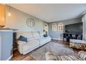 Bright living room featuring modern gray walls, hardwood flooring, and comfortable seating at 3493 S Eudora St, Denver, CO 80222