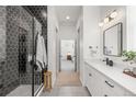 Modern bathroom featuring a tiled walk-in shower, sleek vanity, and stylish fixtures at 16722 Shoshone St, Broomfield, CO 80023