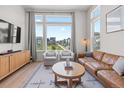 Comfortable living room with large windows, a leather sofa, and stylish decor at 16722 Shoshone St, Broomfield, CO 80023