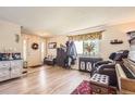 Open entryway with light wood floors and a decorative cabinet and coat rack at 4276 S Tempe Ct, Aurora, CO 80018