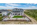 Backyard features an outdoor kitchen, patio, and an artificial lawn surrounded by landscaping at 3459 Hotpepper Way, Castle Rock, CO 80108