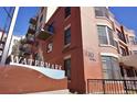 Watermark building exterior showcasing brick facade, balconies, and address signage at 410 Acoma St # 605, Denver, CO 80204