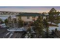 Exterior view of two-story home with green roof and snowy landscape at 2776 Savage Rd, Elizabeth, CO 80107