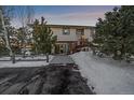 House exterior showcasing entrance, landscaping, and snowy surroundings at 2776 Savage Rd, Elizabeth, CO 80107