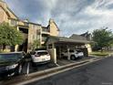 View of the exterior of the building featuring covered parking at 7355 S Alkire St # 203, Littleton, CO 80127