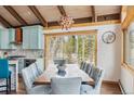 Open dining area with views and modern light fixture, flows into the kitchen and living room at 142 High Point Dr, Breckenridge, CO 80424