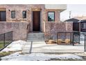 Brick front entrance with steps leading to a modern brown door at 419 Harrison St, Denver, CO 80206