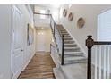 Inviting foyer with a soaring ceiling, staircase, and wood-look floors creates a grand entrance at 2065 E 150Th Pl, Thornton, CO 80602