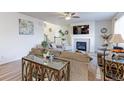 Comfortable living room features a fireplace, large window, and ample seating at 2065 E 150Th Pl, Thornton, CO 80602