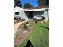 Landscaped front yard with walkway leading to home's entrance at 488 S Leyden St, Denver, CO 80224
