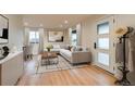 Bright living room features a modern sofa, stylish coffee table, and large windows for abundant natural light at 488 S Leyden St, Denver, CO 80224