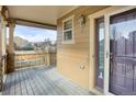 Covered front porch with wooden flooring and a view of the neighborhood at 21719 E Tallkid Ave, Parker, CO 80138