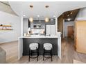 Modern kitchen with stainless steel appliances, island with counter seating, and pendant lighting at 891 14Th St # 1211, Denver, CO 80202