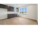 Bright kitchenette features dark cabinets, stainless steel appliances, and a window with a beautiful lake view at 2321 Lakeshore Ln # 10, Superior, CO 80027