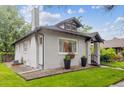 Charming home exterior with a well-maintained lawn and easy access to the basement at 1870 S Ogden St, Denver, CO 80210