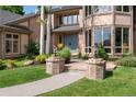 Inviting front entrance with brick pillars, walkway, blue door, and lush landscaping at 3933 W 102Nd Ave, Westminster, CO 80031