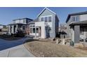 Charming two-story home features a modern design with blue and white exterior at 1732 Stable View Dr, Castle Pines, CO 80108