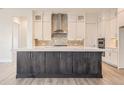 Modern kitchen with white cabinets, stainless steel appliances, and a large island at 11452 Autumn Moon St, Littleton, CO 80125