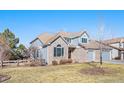 Charming home featuring brick and light blue siding, arched windows and attached garage at 23453 Painted Hills St, Parker, CO 80138