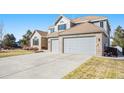 Charming two-story home featuring an attached two car garage and long driveway at 23453 Painted Hills St, Parker, CO 80138