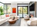 Bright living room with large windows, modern fireplace, and comfortable white couches at 4200 W 17Th Ave # 53, Denver, CO 80204