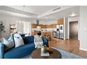 View of an open concept living and kitchen space featuring stainless steel appliances and hardwood floors at 410 Acoma St # 309, Denver, CO 80204