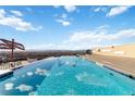Stunning rooftop pool with mountain views and lounge area on a sunny day at 410 Acoma St # 309, Denver, CO 80204