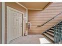 Condo entrance featuring a door with visible unit number and staircase at 10787 Twenty Mile Rd # 205, Parker, CO 80134