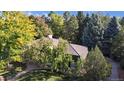 Aerial view of a home with a brown roof surrounded by mature trees, offering privacy and shade at 5432 S Dayton Ct, Greenwood Village, CO 80111