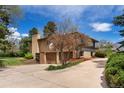 View of the side of the property showing the garage, mature trees, and professional landscaping at 5503 W Colorado Ave, Lakewood, CO 80232