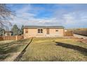 Charming single-story home features a well-maintained lawn and inviting front entrance at 7892 Beverly Blvd, Castle Pines, CO 80108