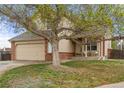 Charming two-story home features a brick facade, two-car garage, and inviting front porch at 1261 E 135Th Pl, Thornton, CO 80241