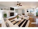 Virtually staged living room with hardwood floors and fireplace at 445 Tumbleweed Dr, Brighton, CO 80601