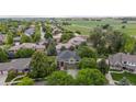 A lovely home surrounded by lush trees with green lawns, backing to a farm in a quiet neighborhood at 2240 Summitview Dr, Longmont, CO 80504