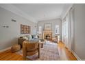 Bright living room features fireplace, hardwood floors, and neutral paint scheme at 2065 Leyden St, Denver, CO 80207