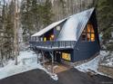 Charming A-frame home featuring a metal roof, large windows, and a spacious deck, set in a snow-covered mountain landscape at 6365 Highway 9, Breckenridge, CO 80424
