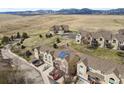 Aerial view of townhomes nestled in a natural setting with mountain views in the distance at 1747 High Plains Ct, Superior, CO 80027