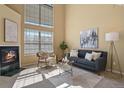 Bright living room featuring a cozy fireplace, large windows and contemporary decor at 1747 High Plains Ct, Superior, CO 80027