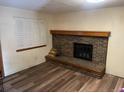 Living room with beautiful floors and brick fireplace at 14828 E Pacific Pl, Aurora, CO 80014
